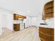 Bright and updated kitchen with wooden cabinets, white appliances, and tile backsplash at 709 S A St, Elwood, IN 46036