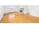 Sunlit living room featuring hardwood floors and a cozy brick fireplace at 709 S A St, Elwood, IN 46036