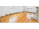 Bright living room with beautiful hardwood floors and a charming decorative fireplace at 709 S A St, Elwood, IN 46036