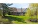 Expansive backyard with mature trees and lush green lawn and landscaping at 7371 Windridge Way, Brownsburg, IN 46112