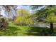 Secluded backyard with a lush lawn and peaceful water views at 7371 Windridge Way, Brownsburg, IN 46112