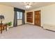 Neutral bedroom featuring a large window, side table, and wooden bookshelf at 7371 Windridge Way, Brownsburg, IN 46112