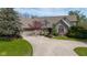 Charming brick home featuring an attached garage, mature trees, and a concrete driveway at 7371 Windridge Way, Brownsburg, IN 46112