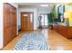 Inviting foyer with hardwood floors, a stylish rug, and a beautiful front door at 7371 Windridge Way, Brownsburg, IN 46112