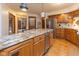 Well-lit kitchen with custom cabinets, stainless steel appliances, and granite countertops at 7371 Windridge Way, Brownsburg, IN 46112