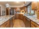 Spacious kitchen with stainless steel appliances, island with granite counters, and wood cabinets at 7371 Windridge Way, Brownsburg, IN 46112