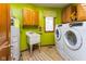 Bright laundry room with washer, dryer, utility sink, and ample cabinet space at 7371 Windridge Way, Brownsburg, IN 46112