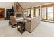 Sunlit living room with fireplace, comfortable seating, and large windows with outdoor views at 7371 Windridge Way, Brownsburg, IN 46112