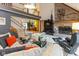 Open living room with a brick fireplace, plush seating, and a view of the upper level at 7371 Windridge Way, Brownsburg, IN 46112