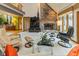 A spacious living room with a brick fireplace, plush seating, and natural light at 7371 Windridge Way, Brownsburg, IN 46112