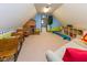 Finished attic playroom with a sofa, school desks, playhouse, and shelves at 7371 Windridge Way, Brownsburg, IN 46112