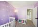 Bright Bedroom decorated with daisy accents on the walls, with a doorway leading to another room at 7418 Bluebird Ct, Indianapolis, IN 46254