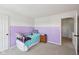 Bright bedroom with soft carpet, a twin bed, a nightstand, and custom painted walls at 7418 Bluebird Ct, Indianapolis, IN 46254