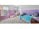 Comfortable bedroom with a twin bed, a large window, and custom paint on the walls at 7418 Bluebird Ct, Indianapolis, IN 46254