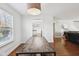 Adjacent to the kitchen, a dining area features a table, and natural light at 7418 Bluebird Ct, Indianapolis, IN 46254