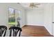 Bright dining area features hardwood floors, a ceiling fan, and sliding glass doors to the yard at 7418 Bluebird Ct, Indianapolis, IN 46254