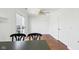 Bright dining area features hardwood floors, a ceiling fan, and sliding glass doors to the yard at 7418 Bluebird Ct, Indianapolis, IN 46254