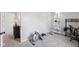Exercise room area with fitness equipment, workspace setup, and natural light at 7418 Bluebird Ct, Indianapolis, IN 46254