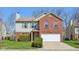 Charming two-story home with a combination of red brick and gray siding at 7418 Bluebird Ct, Indianapolis, IN 46254