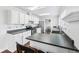 Kitchen with skylight, stainless steel appliances, white cabinets, and breakfast bar seating at 7418 Bluebird Ct, Indianapolis, IN 46254