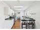 Kitchen features stainless appliances, skylights, a breakfast bar and white shaker cabinets at 7418 Bluebird Ct, Indianapolis, IN 46254