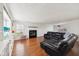 Bright living room with fireplace, hardwood floors and custom built-in shelving at 7418 Bluebird Ct, Indianapolis, IN 46254