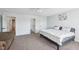 Bright and spacious main bedroom featuring neutral carpeting, and multiple doors offering flexible space at 7418 Bluebird Ct, Indianapolis, IN 46254