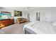 Bright main bedroom features neutral carpeting, a sitting area, and multiple doors offering additional flexible space at 7418 Bluebird Ct, Indianapolis, IN 46254