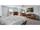 Bright main bedroom features two windows, a ceiling fan, a sitting area, and neutral carpeting for a cozy atmosphere at 7418 Bluebird Ct, Indianapolis, IN 46254