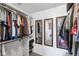 Spacious walk-in closet with custom shelving, hanging racks, and multiple mirrors, perfect for organizing attire at 7418 Bluebird Ct, Indianapolis, IN 46254