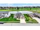 Aerial view of a neighborhood with pond and fountain surrounded by mature landscaping and golf course at 749 Meadowbrook Ln, Franklin, IN 46131