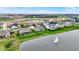 An aerial view features lakeside homes with lush green lawns and beautiful water feature at 749 Meadowbrook Ln, Franklin, IN 46131