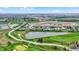Aerial view features homes surrounding a pond and a well-maintained green space in a community at 749 Meadowbrook Ln, Franklin, IN 46131