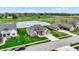 Aerial view of a residential area featuring homes, green spaces, and a pond with fountain feature at 749 Meadowbrook Ln, Franklin, IN 46131