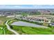 Aerial view of a community highlighting a pond with fountain and surrounding green spaces at 749 Meadowbrook Ln, Franklin, IN 46131