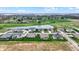 Wide aerial view of a housing community, pond with fountain, and green golf course behind houses at 749 Meadowbrook Ln, Franklin, IN 46131