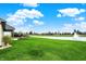 Lush green backyard offering serene water views, a beautifully landscaped patio and well-maintained lawn at 749 Meadowbrook Ln, Franklin, IN 46131