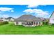 Beautiful backyard view showcasing a large lawn and inviting covered patio area, perfect for entertaining at 749 Meadowbrook Ln, Franklin, IN 46131