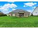 Expansive backyard featuring a covered patio and lush lawn, creating a perfect outdoor space at 749 Meadowbrook Ln, Franklin, IN 46131