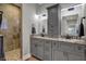 Bathroom featuring double vanity with granite counters, tiled shower, and modern fixtures at 749 Meadowbrook Ln, Franklin, IN 46131