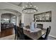 Elegant dining room with a modern chandelier, decorative mirror, and seating for six at 749 Meadowbrook Ln, Franklin, IN 46131