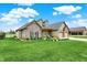 Charming home with lush lawn, stone accents, and a two-car garage on a sunny day at 749 Meadowbrook Ln, Franklin, IN 46131