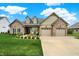 Beautiful stone and siding home with a well-manicured lawn and a two-car garage at 749 Meadowbrook Ln, Franklin, IN 46131