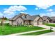 Charming home with manicured lawn, stone accents, and a two-car garage on a sunny day at 749 Meadowbrook Ln, Franklin, IN 46131