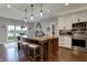 Bright eat-in kitchen with granite island and stainless appliances, adjacent to a cozy breakfast nook at 749 Meadowbrook Ln, Franklin, IN 46131