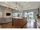 Modern kitchen with a central island, stainless appliances, and an open layout connecting to the living area at 749 Meadowbrook Ln, Franklin, IN 46131