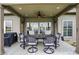 Covered patio with an outdoor dining set, ceiling fan, and grill perfect for entertaining guests at 749 Meadowbrook Ln, Franklin, IN 46131