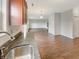 Open-concept kitchen with granite counters, stainless sink, and hardwood floors flowing into the living area at 771 Carolina Way, Avon, IN 46123