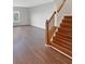 Inviting living space featuring sleek hardwood flooring and staircase at 771 Carolina Way, Avon, IN 46123