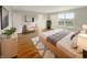 Serene main bedroom with a king bed, accent chair, neutral walls, and a bright window at 771 Carolina Way, Avon, IN 46123